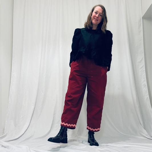 Red barrel-leg trousers with pink zig zags