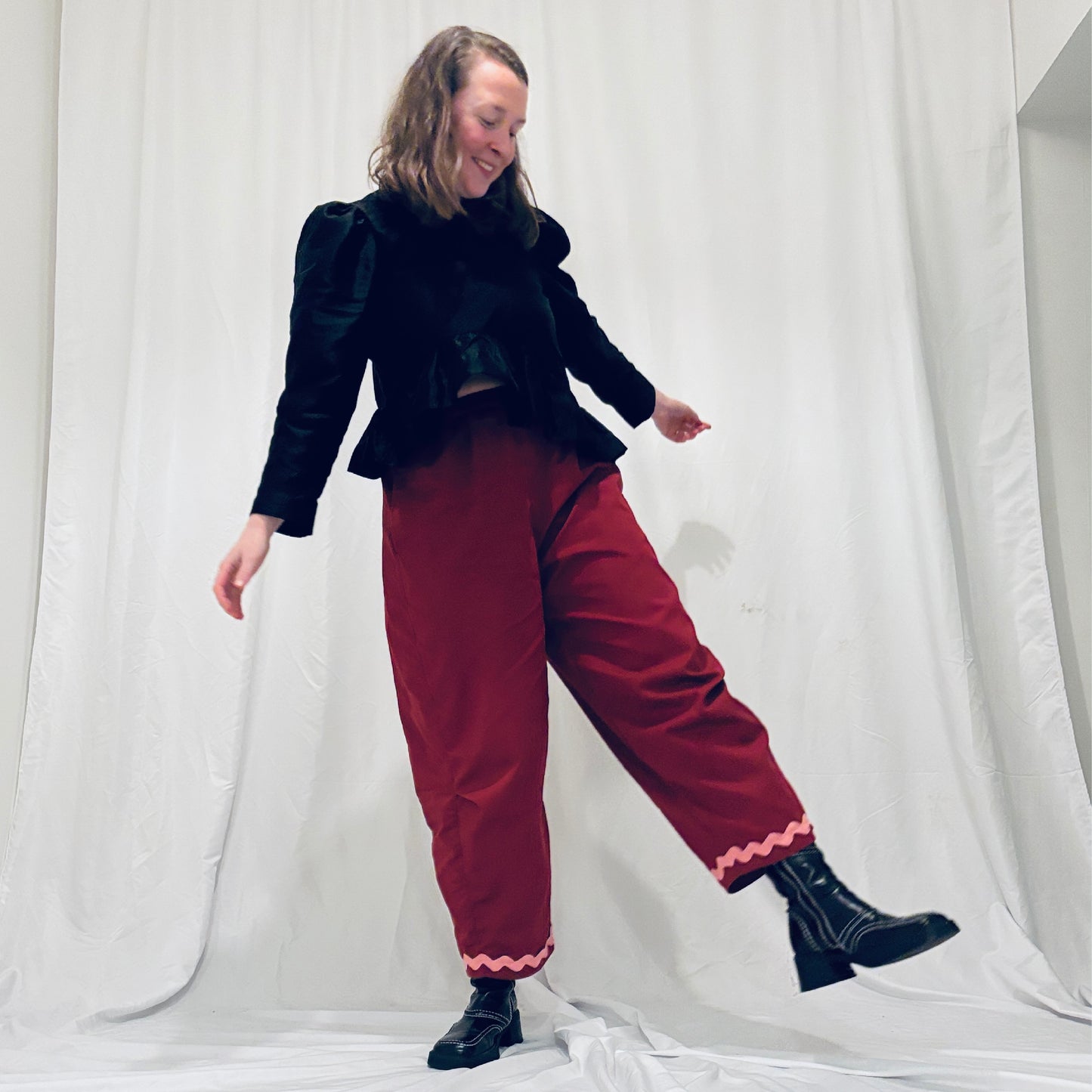 Red barrel-leg trousers with pink zig zags