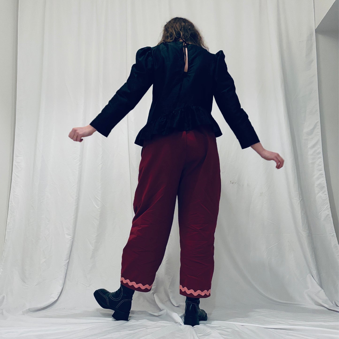 Red barrel-leg trousers with pink zig zags